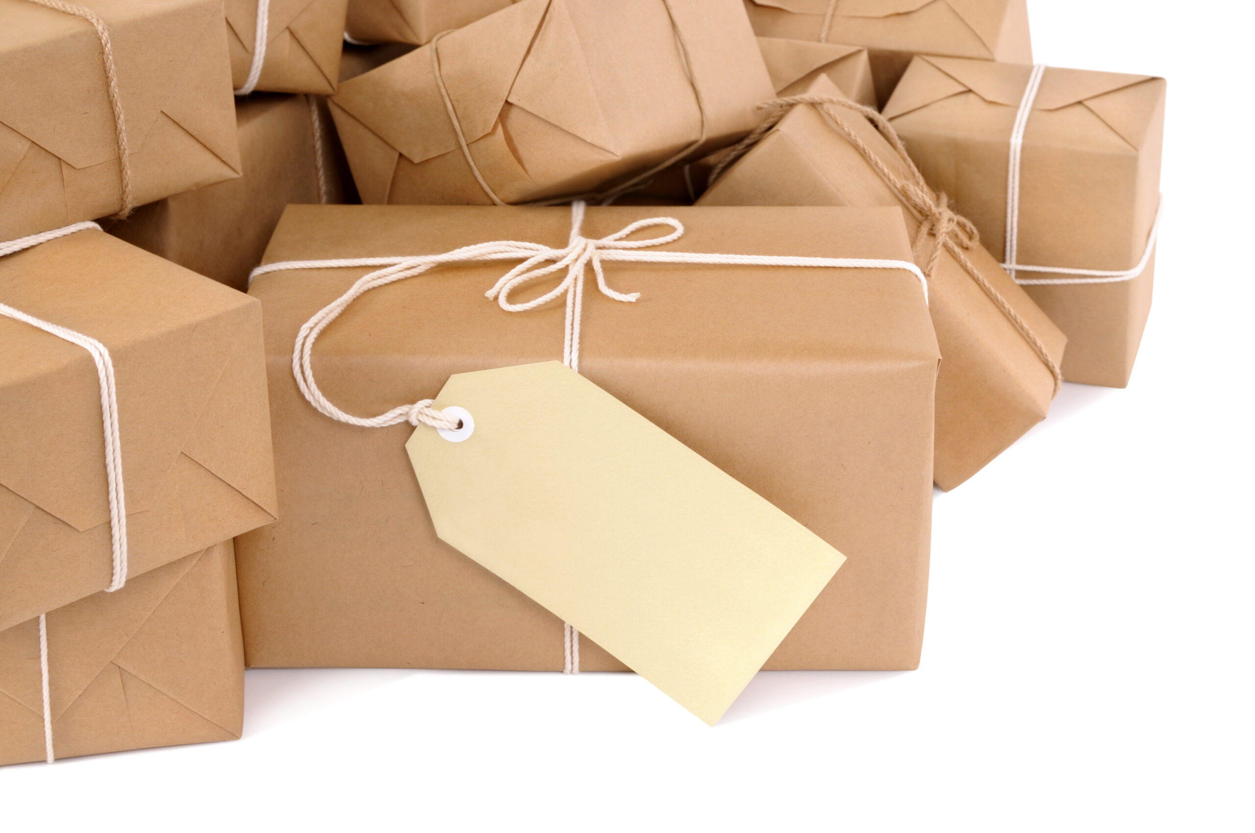 Untidy pile of brown parcels with label